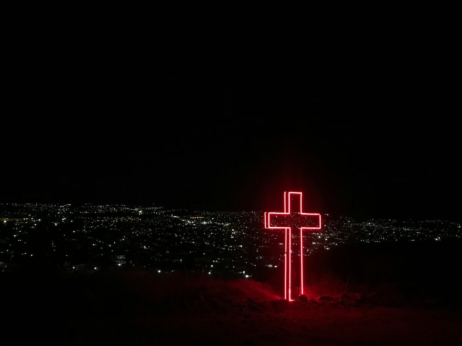 red neon light cross